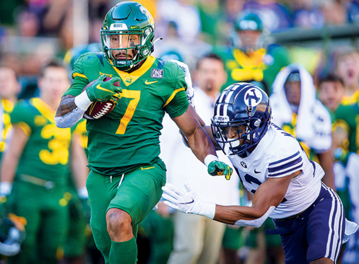 Baylor Bears running back Abram Smith (7) runs for a first down as Brigham Young Cougars defensive back Malik Moore (12) chases during the second half at McLane Stadium.